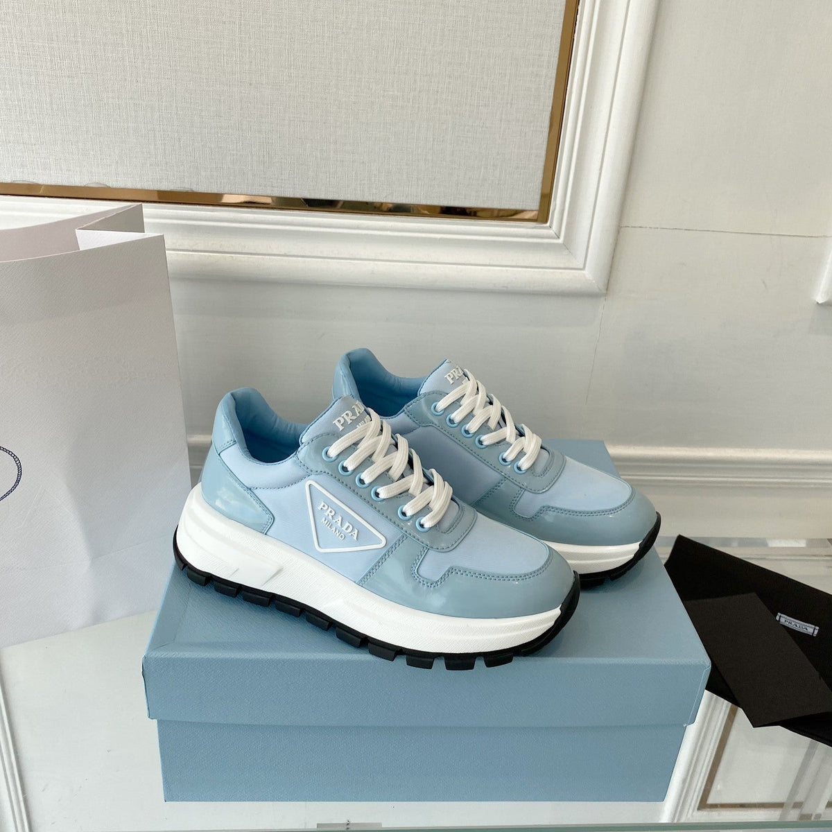 PRADA 25S THICK SOLE SNEAKER IN LIGHT BLUE CALFSKIN AND CANVAS