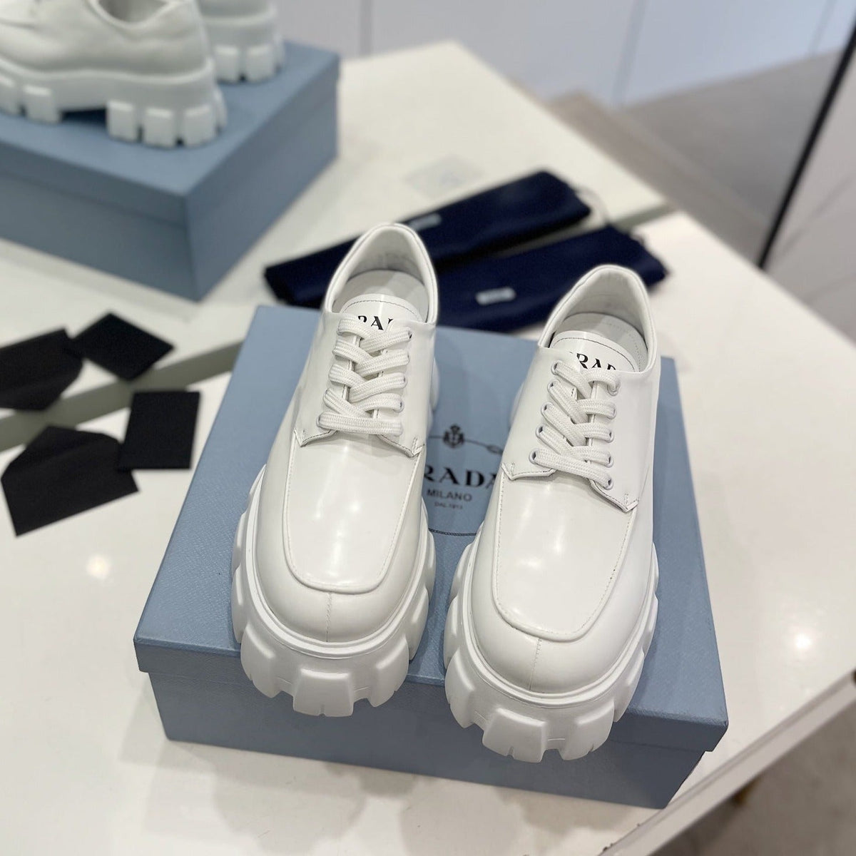 PRADA BRUSHED LEATHER MONOLITH LACE-UP LOAFERS WHITE
