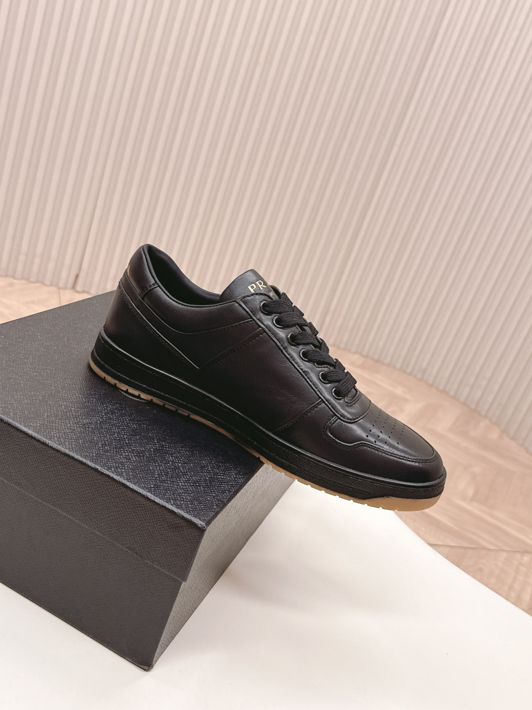 PRADA 25S DOWNTOWN SNEAKERS IN BLACK CALFSKIN