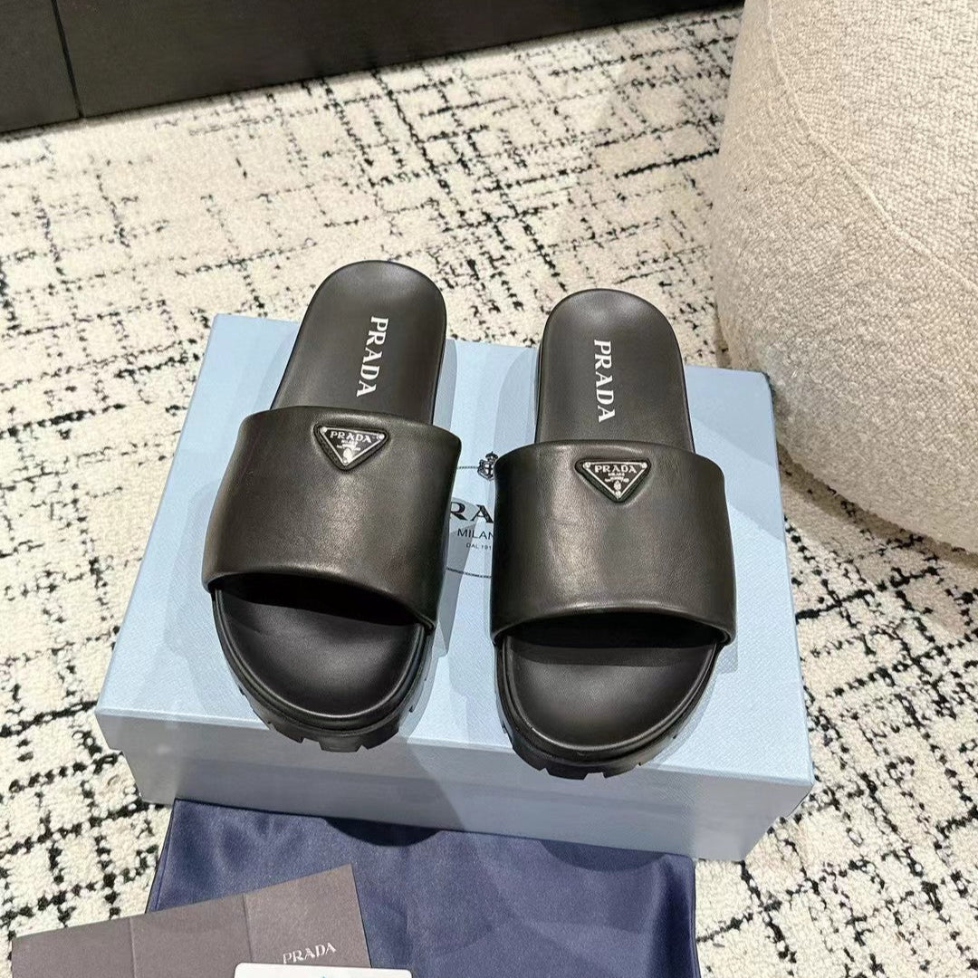 PRADA 25S PADDED SLIDES IN BLACK CALFSKIN WITH LOGO