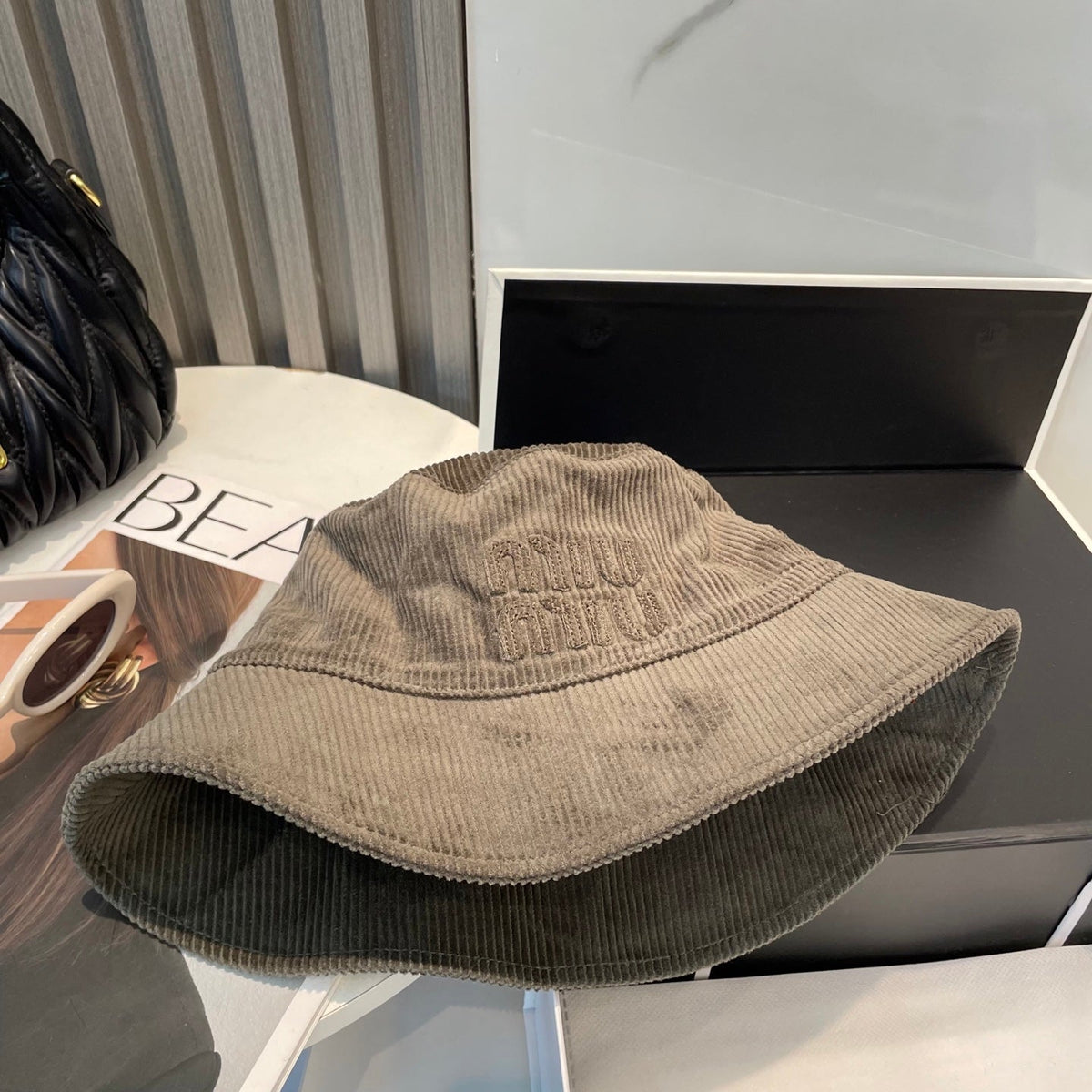 MM BUCKET IN MUTED BROWN VELVET WITH LOGO